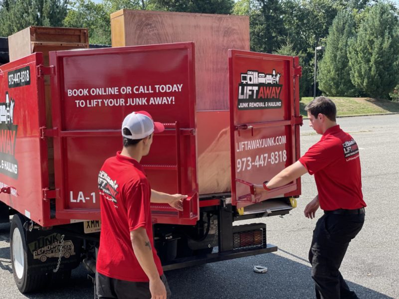 Lift Away Junk Removal & Hauling pros hauling junk to a junk truck