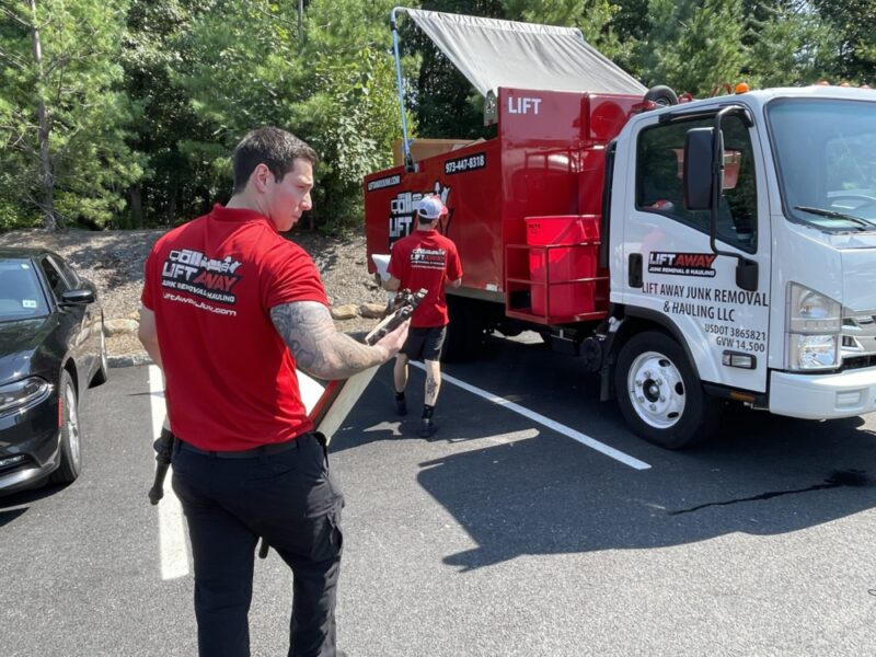 Lift Away professionals hauling furniture to a junk truck