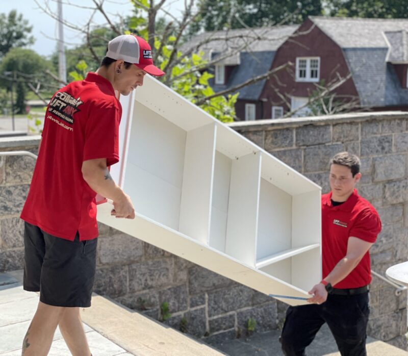 Lift Away Junk Removal experts hauling away a bookshelf