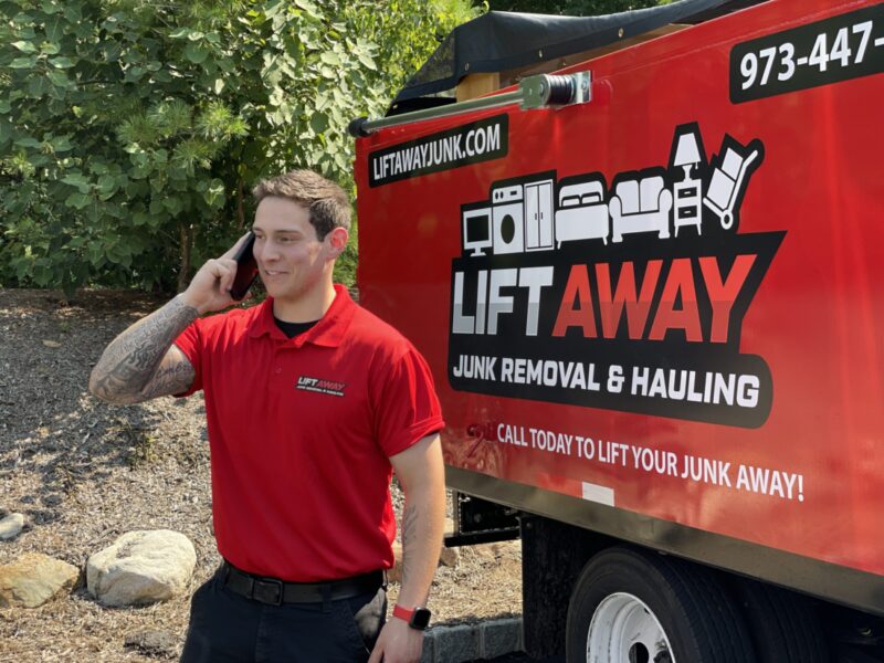 A Lift away junk removal & hauling pro on the phone with a customer